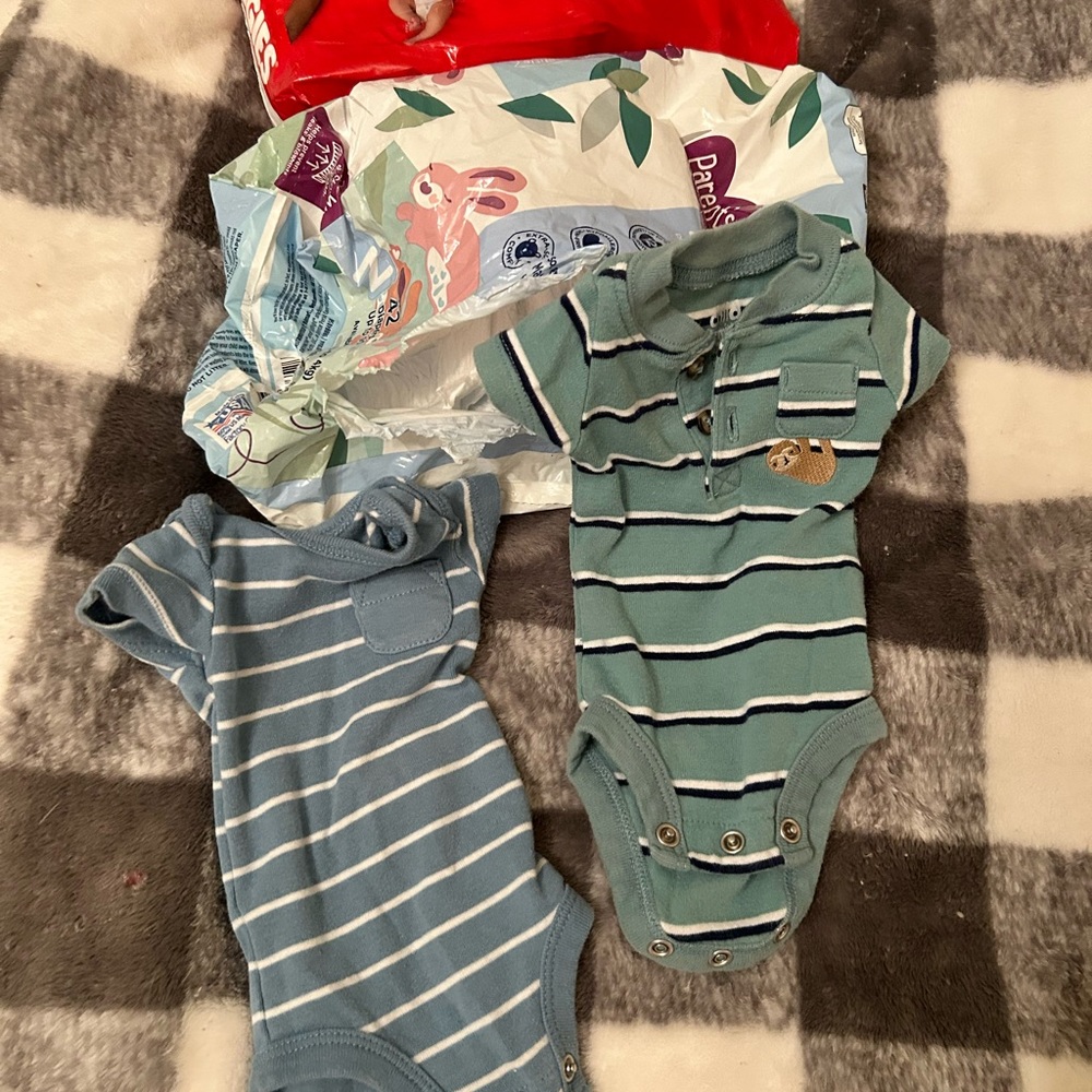 Lot of 4 , I found 2 more.Preemie onesies and apox 60 Diapers!